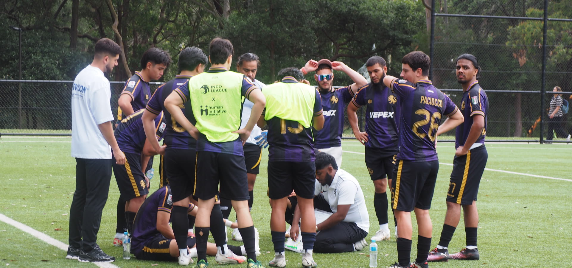 The KOMO squad in a huddle on the pitch